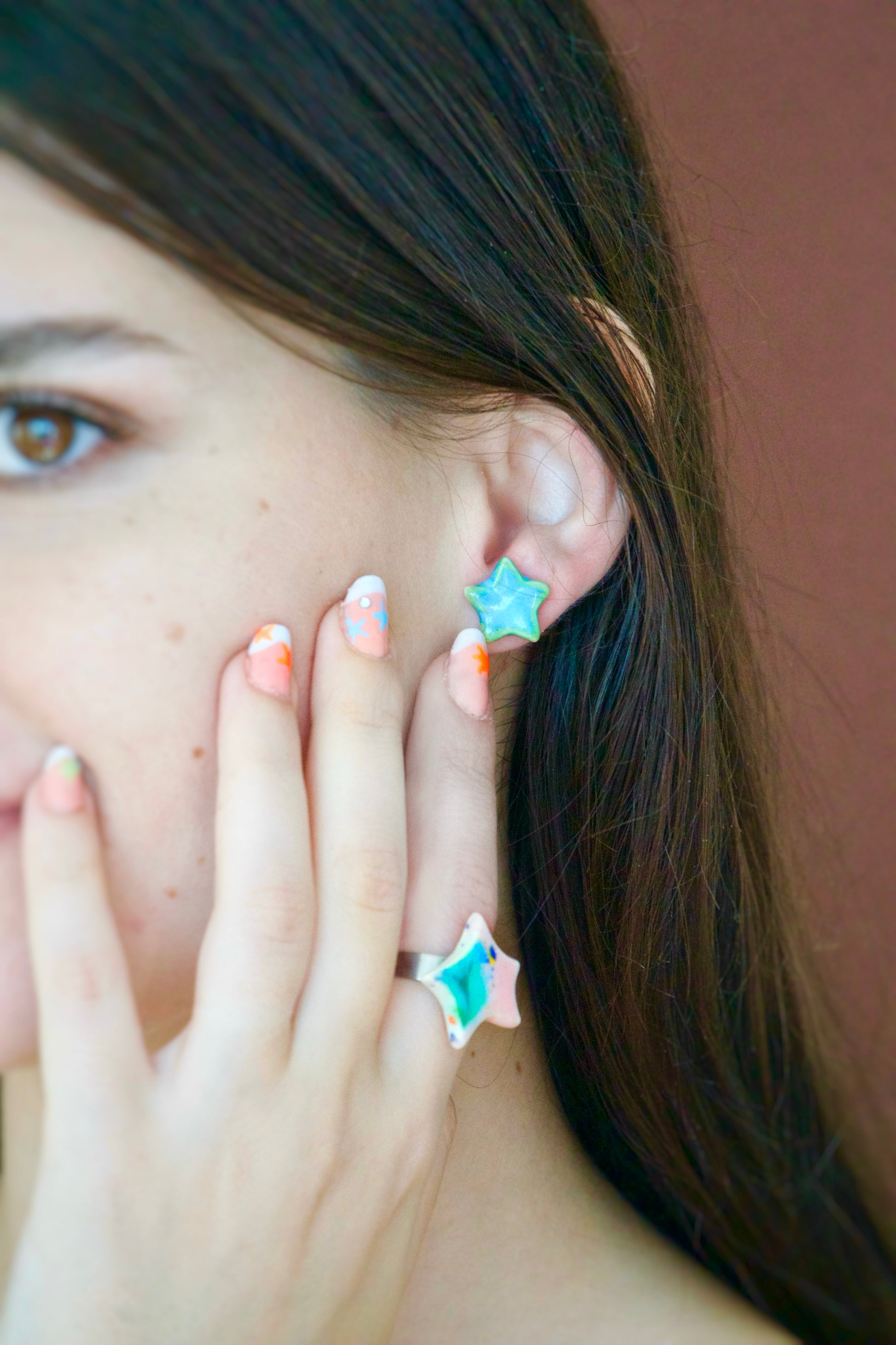 Cercei handmade din porțelan în formă de steluțe verzi cu accente albastre, finisaj lucios, tije hipoalergenice.