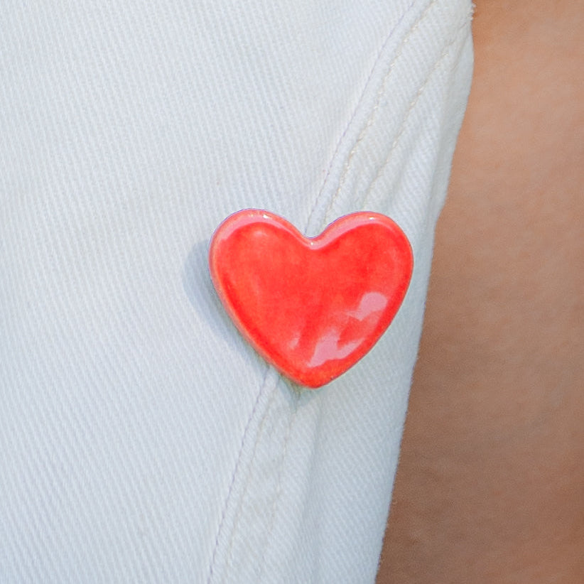Brosa din ceramica in forma de inima rosie.